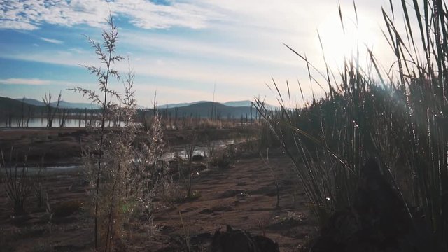 camera pulling back at the side of lake at Barage Sidi Barak in the Morning