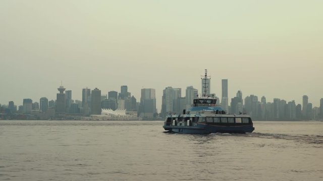 Sea bus leaving Lonsdale Quay and cruising towards Vancouver downtown