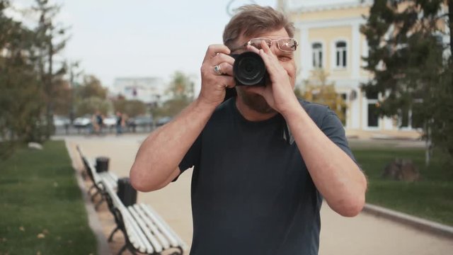 Traveling adult man take a picture in front of the camera.