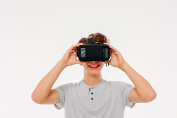 Young man teenager student wearing virtual reality glasses on white background