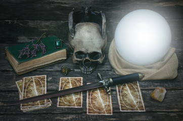Tarot cards and crystal ball on fortune teller desk table background. Futune reading concept....