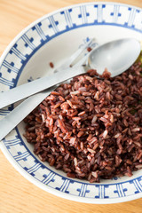 Close up of steamed rice berry in plate on wooden table
