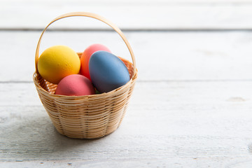 Colored easter eggs on white wooden