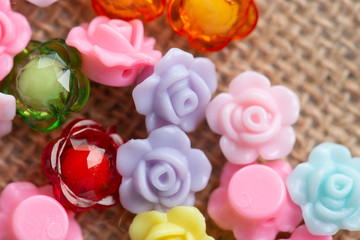 Colorful flower plastic beads on wooden