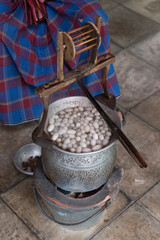 Boiling silkworm cocoon in the pot with hot water