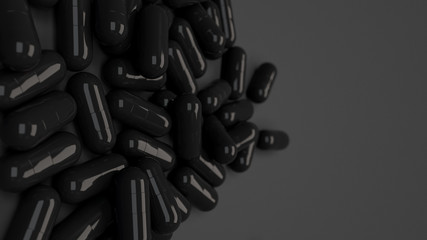 Pile of black medicine capsules