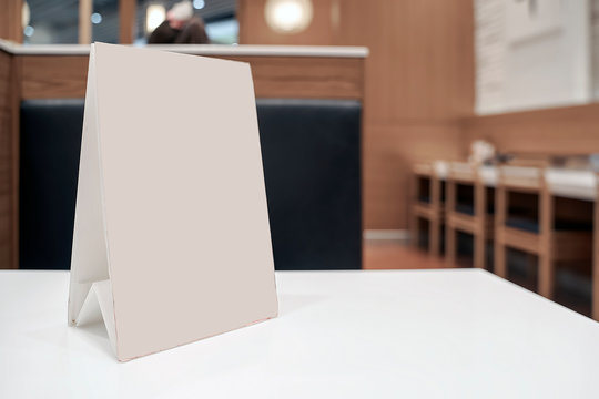Mock up menu frame with blank page on table