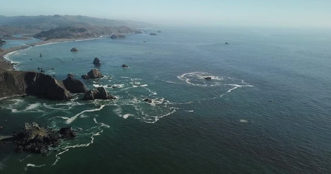 Cinematic drone footage a of a cove and the mouth of the Russian river. Partly loudy day. Clear conditions. Footage was taken near Jenner, CA on the Sonoma Coast.