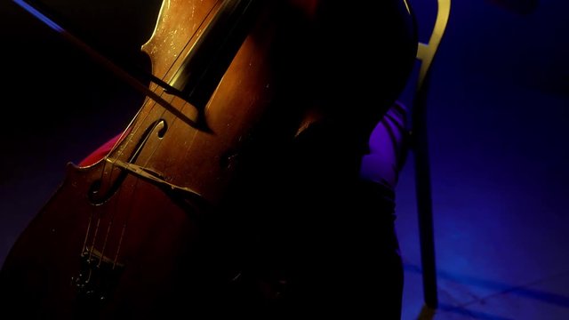 The cellist performs on stage.