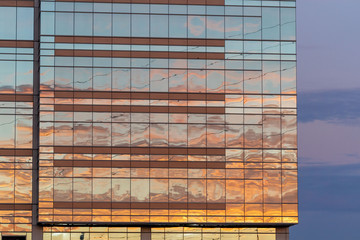 Business office building with colorful skies, reflecting the sunset colors of the glass windows
