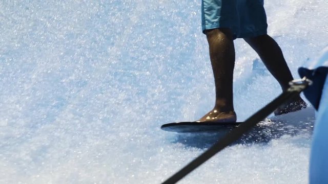 Skilled surfer carves on wave machine slow motion