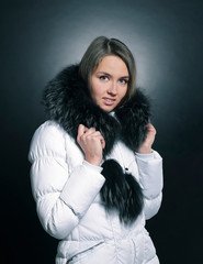 portrait of beautiful young woman in winter jacket