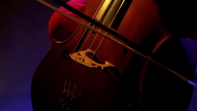 The cellist performs on stage.