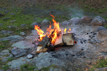A small fire on the ground in the evening