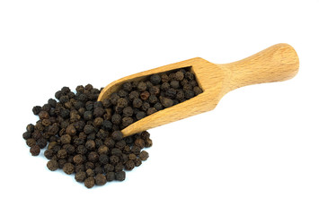 Black pepper on wooden scoop isolated on white background
