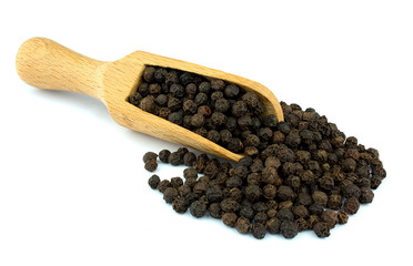 Black pepper on wooden scoop isolated on white background