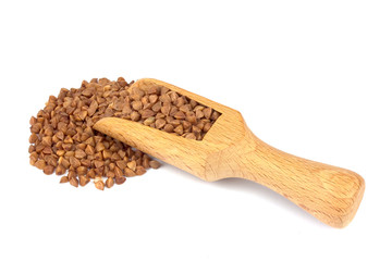 Buckwheat on wooden scoop isolated on white background