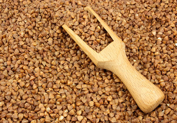 Buckwheat scattered with a wooden scoop