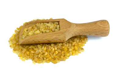 Bulgur or couscous on wooden scoop isolated on white background
