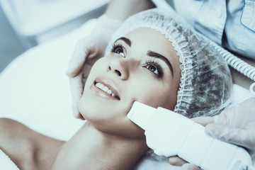 Young Woman in Spa Salon for Laser Hair Removal.