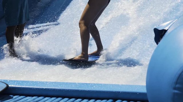 Surfing wave machine, close up on feet
