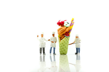 Miniature people : Chef is decorating ice cream with mint and strawberry,cherry,snack