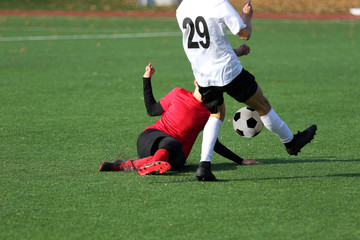 Boys playing a football match and empty space for text