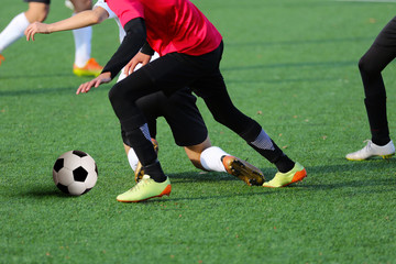 Boys playing a football match and empty space for text