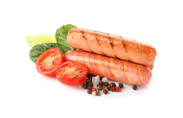 Delicious grilled sausages with tomato and spices on white background