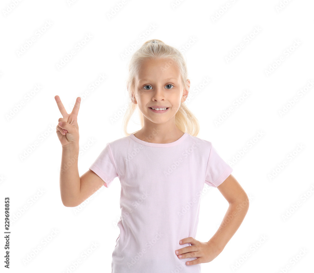 Sticker Cute little girl in t-shirt showing Victory gesture on white background