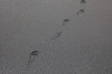 Beautiful black sand with footprints in Hawaii