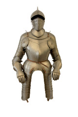 Metal helmet and armor of a medieval knight on a white background