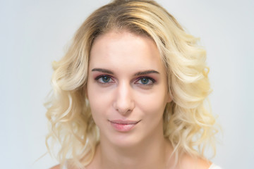 Naklejka premium Beauty portrait of a beautiful blonde girl on a white background with perfect makeup.