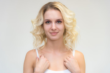 Obraz premium Portrait of a beautiful blonde girl while working as a professional beautician make-up artist.