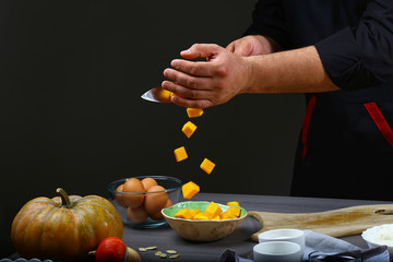Freezer food prepare in process pumpkin pie by chef hand in home kitchen. Dark black background with Text area for design menu restaurant