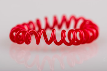 Red spiral on white background. Scrunchy