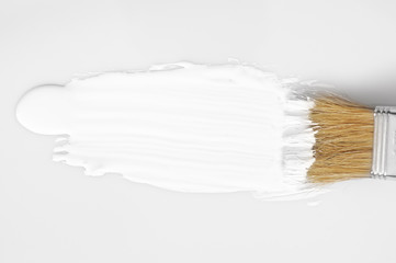 White paint stroke and brush