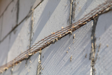 Metal mesh between the bricks in the concrete