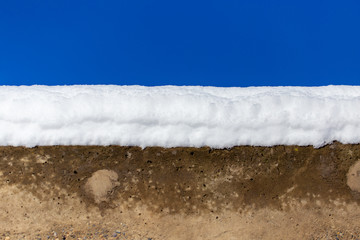 White snow concrete against a blue sky