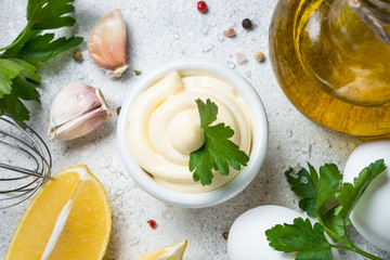 Mayonnaise sauce on white stone table. 