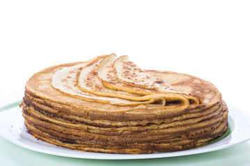 big high stack of thin pancakes in a plate