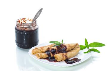 thin fried pancakes stuffed with jam in a plate