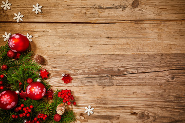 Christmas background with fir tree and decoration on dark wooden board