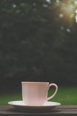 Coffee cup on the table in the cafe.In a cafe with a cup of coffee.Do not focus on objects.