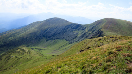 big green mountain ridge, horses on the glade