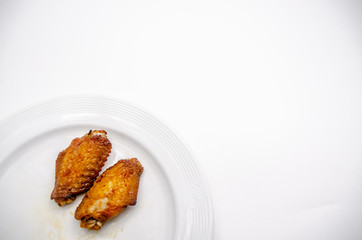 Close up.Fried chicken wings in a white plate.