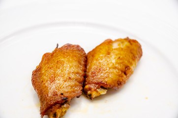 Close up.Fried chicken wings in a white plate.
