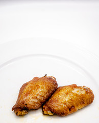Close up.Fried chicken wings in a white plate.