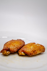 Close up.Fried chicken wings in a white plate.