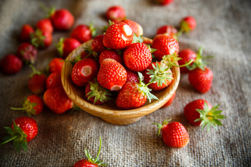 ripe red strawberry on a table with burlap